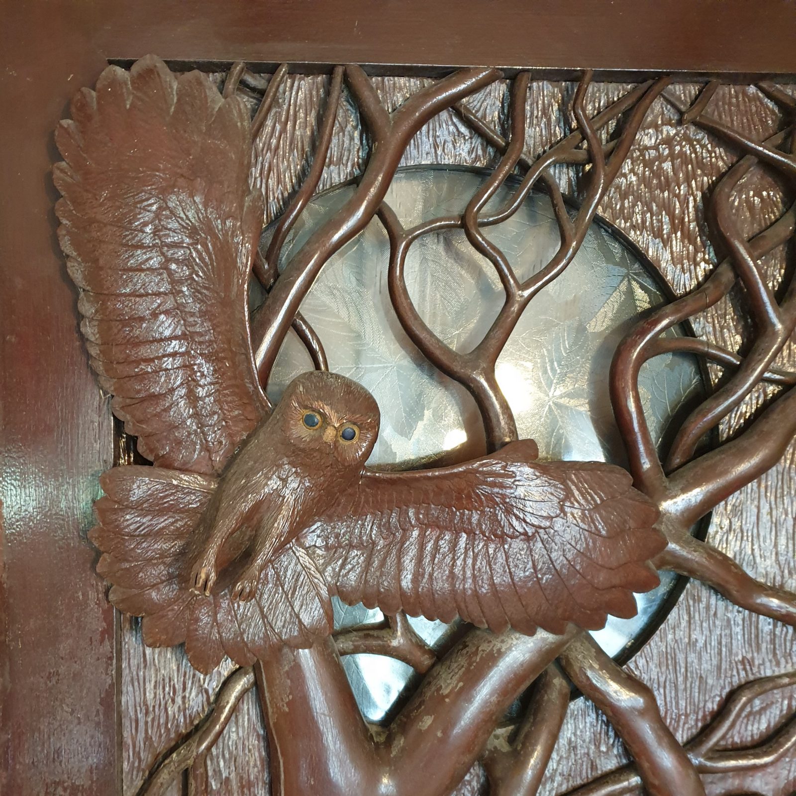This a typical project for our antique restoration workshops.- a unique front door from the 1920's is decorated with a hand carved owl flying in a wooded landscape: 