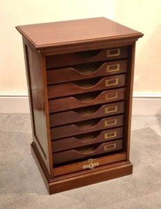 A 1920s mahogany filing cabinet with eight-drawers and a tabour front. Each drawer has its original brass label holder.