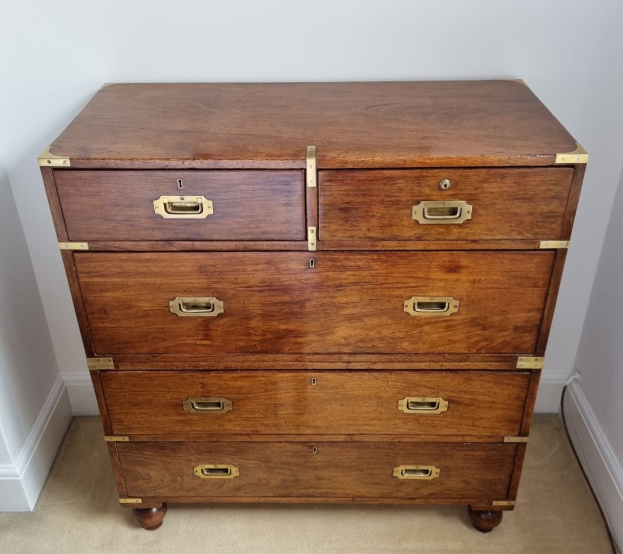 A 19th Century campaign chest of drawers pictured after it was restored by Culvertons of Dorking. 