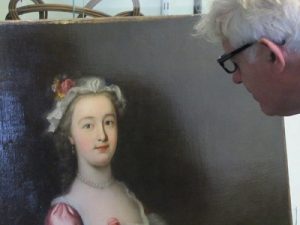 Culvertons' valuation services - our specialist inspects a portrait whilst valuing paintings for the Medway Council.