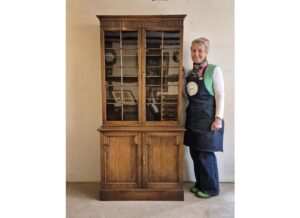 A finely constructed and well proportioned 1920s solid oak bookcase of good colour, with a glazed top and cupboard base.