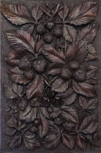 A finely carved American walnut panel, (Circa 1900), depicting an abundance of wild strawberries
